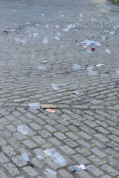 istock A street is littered with trash, including plastic cups and bottles, waste and neglect 2254753367
