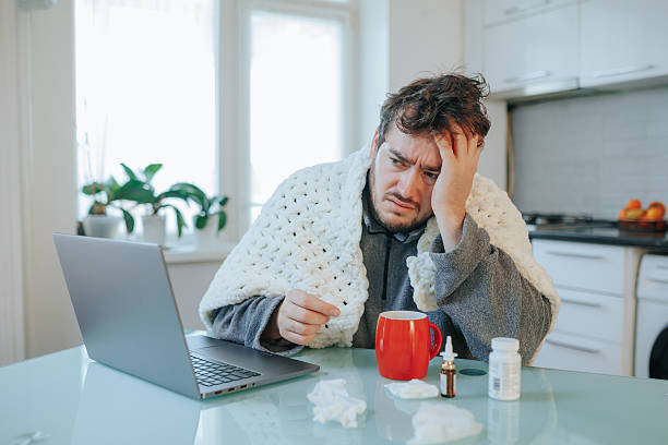 istock Subzero Struggles Amplified Tousled Haired Man Battling Flu Under Duvet 2254754019