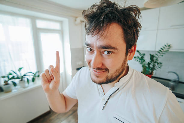 istock A bearded man close up, radiating humor and cheer, as he points with delight 2254754041
