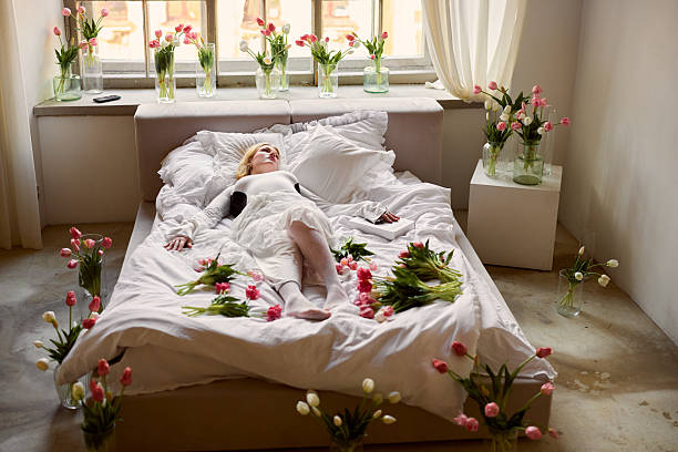 istock Serene bride in floral setting, Calm bride lying peacefully surrounded by vibrant tulip blossoms 2254754184