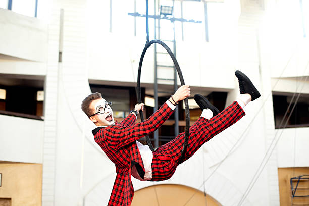 guy mime acrobat in the air on a hoop