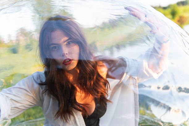 Water ball (similar to zorb or Human Hamster Ball) with young woman inside on pond surface