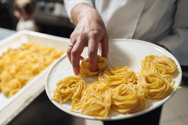 istock Warm kitchen setting with freshly made pasta and artistic touches 2254757056