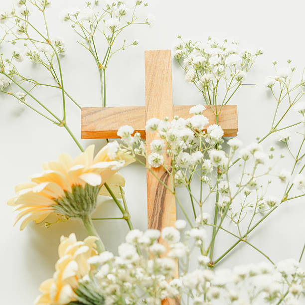 Silhouette of Cross on hilltop.  Yellow flowers background.
