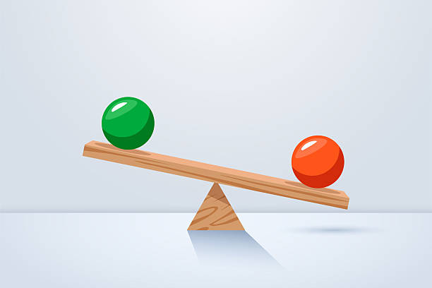 istock Balanced seesaw with green and red balls. Setting for conceptual balance 2254758399