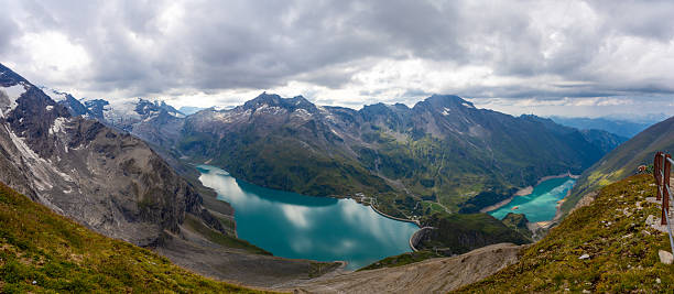 istock Austria Alps landscape with alpine meadows, forested slopes, and rugged mountain peaks under open sky 2254762009