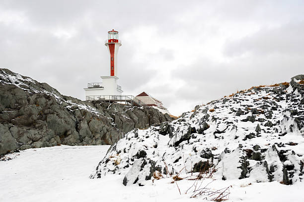 Sturgeon Point Lighthouse on Lake Huron in Michigan on winter day.
