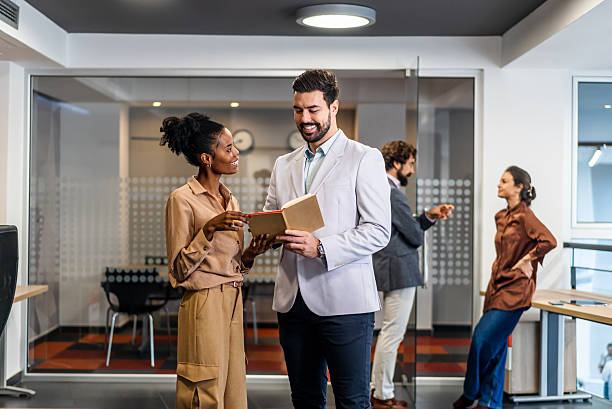 istock Business colleagues collaborating in modern office discussing project 2254765818