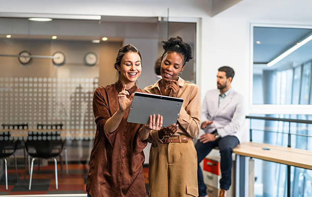 istock Businesswomen discussing data on digital tablet in office 2254766362