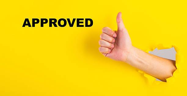 istock Hand giving thumbs up with approved text 2254766442