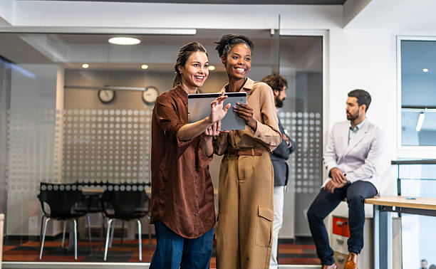 istock Diverse businesswomen collaborating using digital tablets in office 2254767152