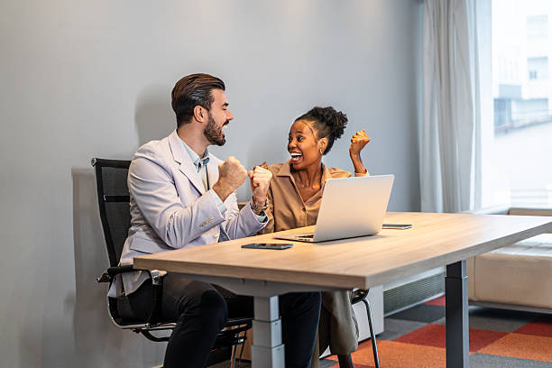 istock Diverse colleagues celebrating business success at modern office 2254767558
