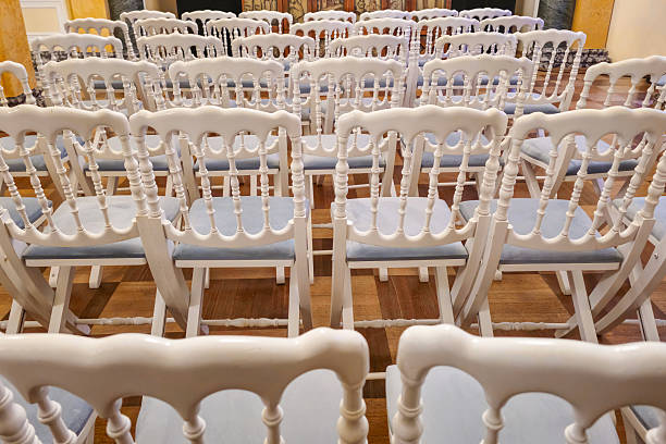 Guest chairs arranged neatly for a wedding ceremony, adorned with elegant decorations. Perfect for themes of celebration, hospitality, or event setup