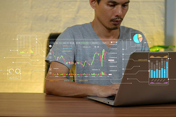 istock Young Man Analyzing Stock Market Data on Laptop with Graphs 2254768377