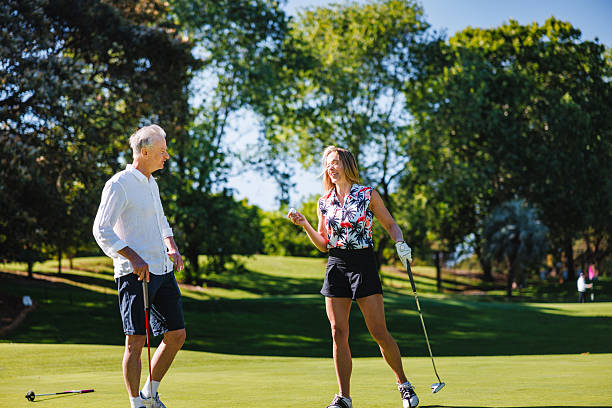 istock Caucasian Couple Enjoying Lively Conversation on Golf Course 2254768424