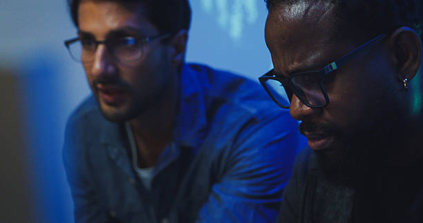 istock Closeup Black and Hispanic male engineers programmers work together collaborate discuss software development strategies in tech office late into the night. Software developer, artificial intelligence. 2254769847
