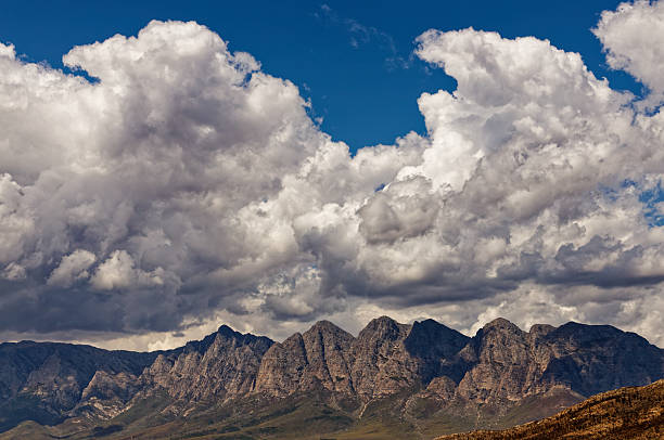 Amazing white clouds against a blue sky and high mountains.
