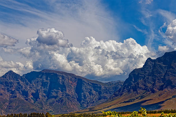 Amazing white clouds against a blue sky and high mountains.