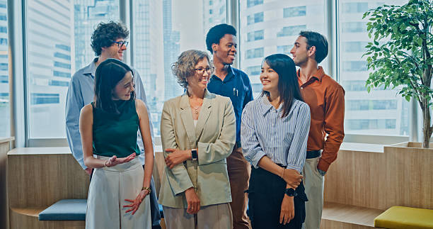 istock Diverse business team smiling looking at camera, representing teamwork, leadership, and success in modern office. Sustainable business and finance concept. 2254772868