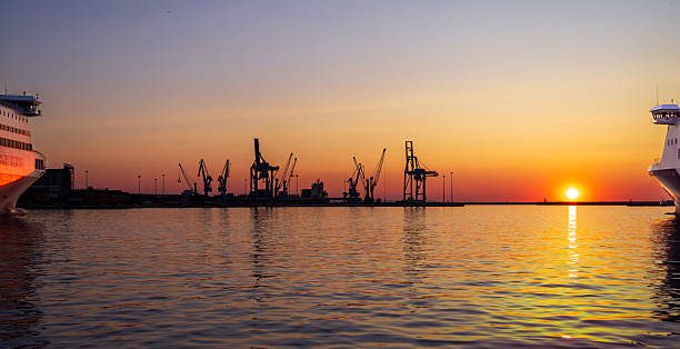 Harbor at Sunset with Passenger Ships and Cargo Terminal stock photo