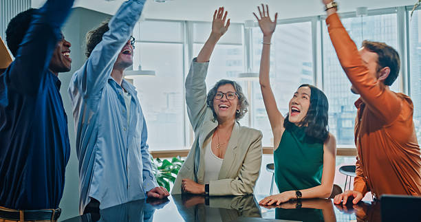 istock Diverse business team celebrating their achievements with unity, teamwork, trust and support, showcasing creativity in modern office. Sustainable business and finance concept. 2254775290