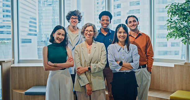 istock Diverse business team smiling looking at camera, representing teamwork, leadership, and success in modern office. Sustainable business and finance concept. 2254775530