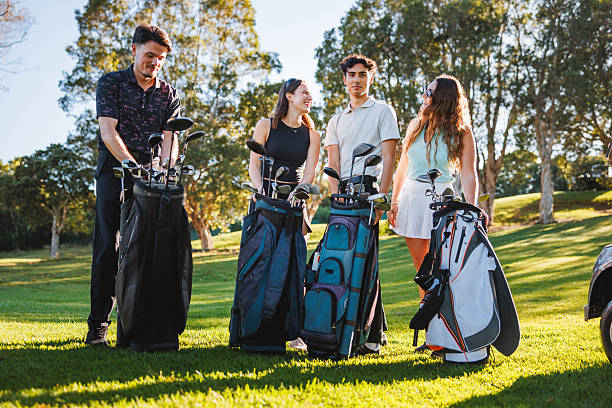 istock Joyful Young Adults Organizing Golf Bags on Sunny Green 2254776708