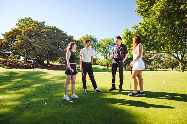 istock Caucasian Young Adults Engaging in Cheerful Golf Discussion on Green 2254777423