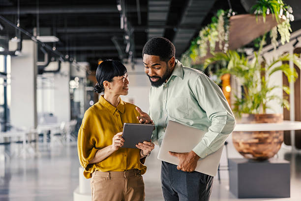 istock Diverse colleagues discussing project information on digital tablet 2254779758