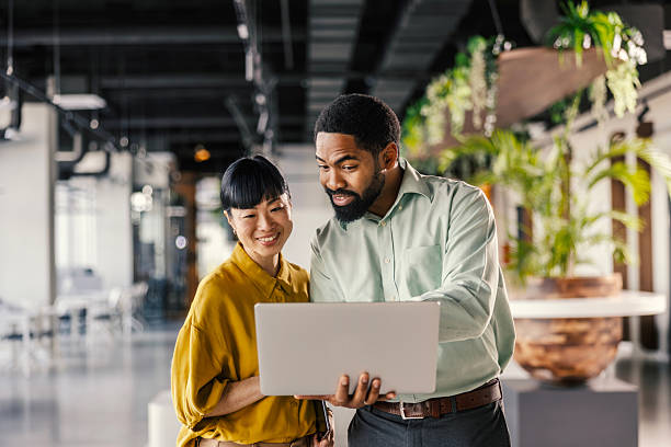 istock Diverse business professionals collaborating on laptop in office 2254779768