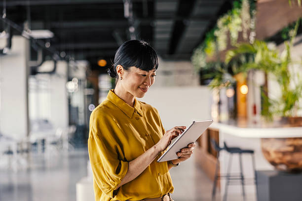 istock Asian businesswoman using digital tablet in office 2254779777