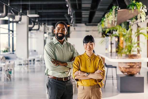 istock Diverse business professionals standing together in modern office 2254779794