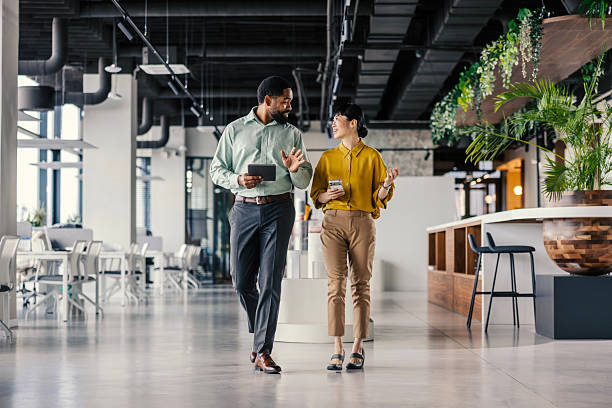 istock Business colleagues walking and discussing in modern office 2254780044