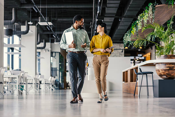 istock Business colleagues walking and discussing in modern office 2254780058