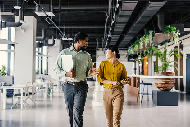 istock Business colleagues collaborating walking through modern office discussing work 2254780071