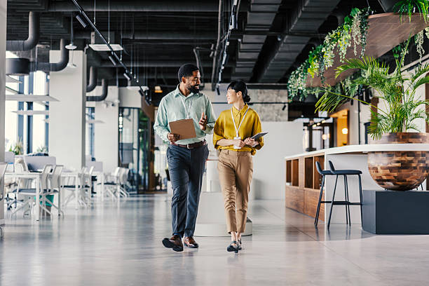 istock Diverse business professionals collaborating in modern office hallway 2254780129