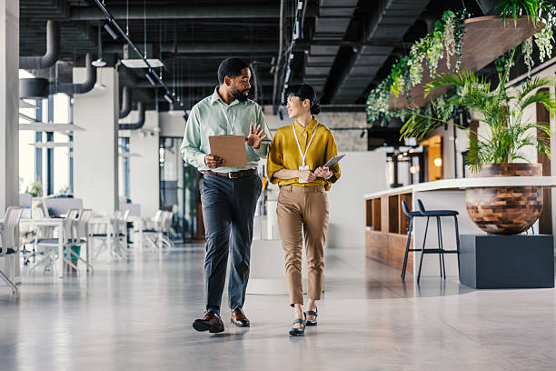 istock Diverse business people discussing while walking in modern office 2254780133