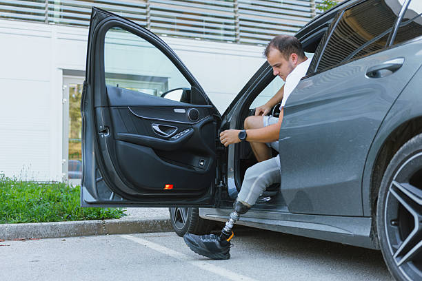 istock Person entering car with prosthetic leg 2254780474