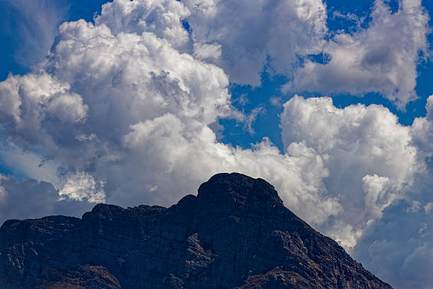 Amazing white clouds against a blue sky and high mountains.