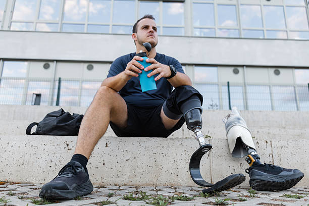 istock Athlete with leg amputation resting on outdoor steps after workout 2254781428