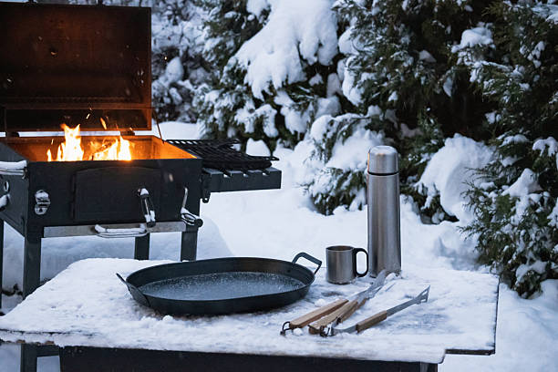 istock Outdoor winter barbecue with fire and cooking tools in snow 2254783659