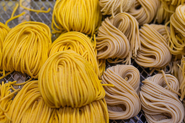 Bologna, Italy - Sep 15th, 2024: A variety of traditional Italian dry pasta and jars of authentic ragù Bolognese on display in a local shop