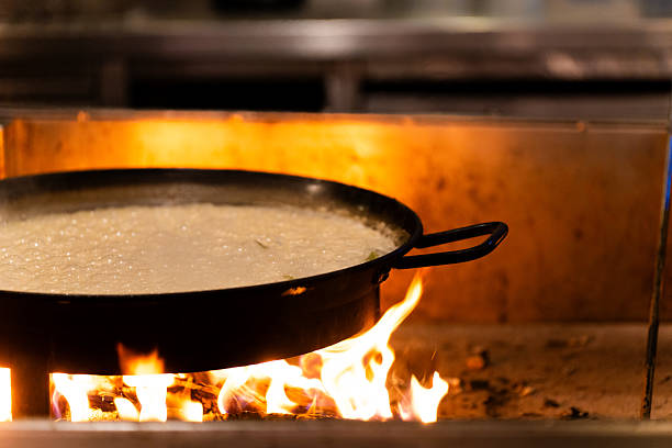 Paella Pan Cooking Rice over Open Flame