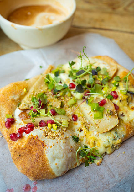 istock Flatbread with Melted Cheese, Pear Slices, and Pomegranate Seeds 2254785101
