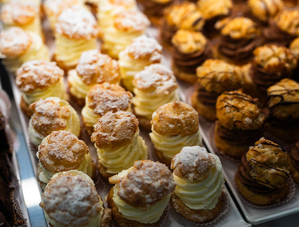 istock Chocolate Cream Profiteroles Displayed in Pastry Case 2254785119