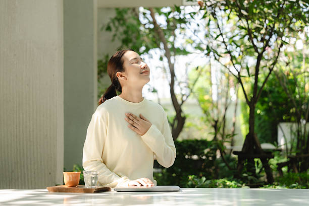 The woman is calming her mind amidst a natural setting.