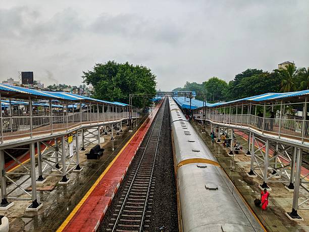 istock A passenger train standing at a railway station platform in India, showing daily commuter life, public transportation, and urban travel infrastructure. 2254786310