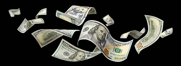 istock Flying hundred dollar banknotes, isolated on black background 2254787882