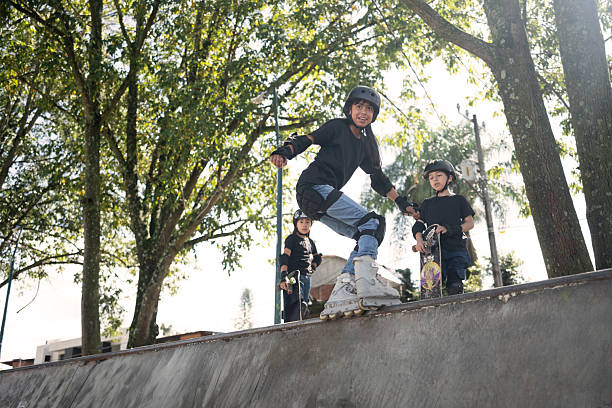 young people and children practicing skating in a skate park