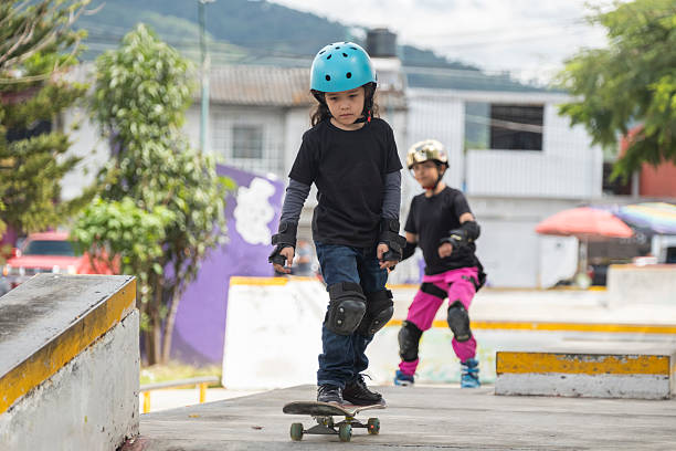 young people and children practicing skating in a skate park